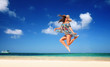 Carefree young woman is jumping into the sky