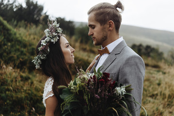 beautiful fabulous happy  bride with bouquet and wreath and styl