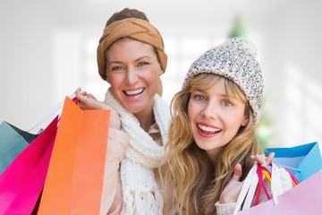 Composite image of smiling women with shopping bags