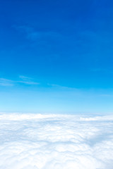 Wall Mural - aerial view of blue sky and cloud top view from airplane window,