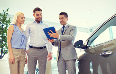 Canvas Print - happy couple with car dealer in auto show or salon