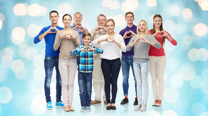  group of smiling people showing heart hand sign
