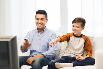 Wall Mural - smiling father and son watching tv at home