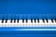 Piano keys of blue piano close up