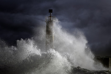 Fototapeta Stormy waves over lighthouse