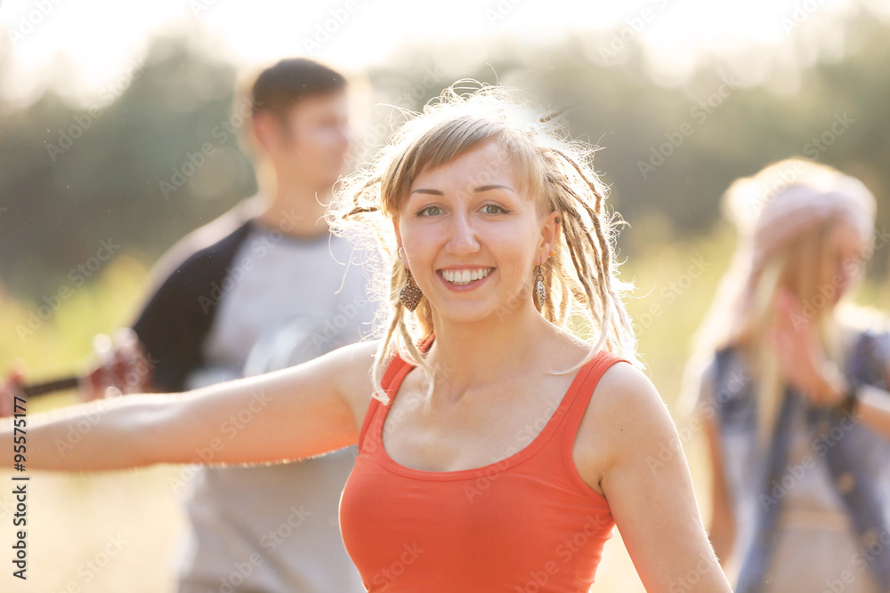 Pretty girl has fun with friends, outdoors