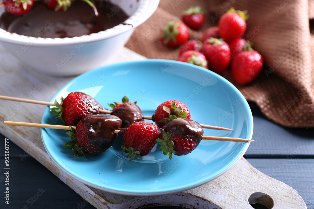 Delicious strawberries in chocolate on kitchen table