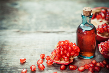 Wall Mural - Pomegranate tincture or  juice and red ripe garnet fruit 