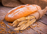 Fototapeta Kuchnia - fresh bread and wheat on the wooden
