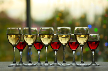 Poster - Wine glasses with wine on a table outside