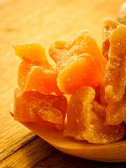 Wall Mural - Closeup root and candied ginger on wooden table