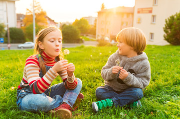 Wall Mural - Two adorable kids playing outdoors at susnet