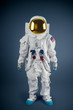 Astronaut standing on a grey background