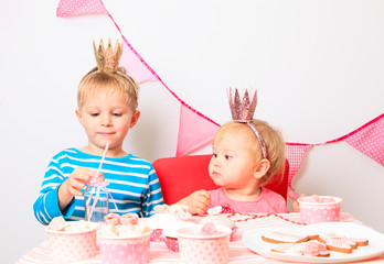 little boy and toddler girl celebrating birthday party