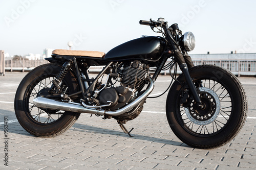 Fototapeta na wymiar Vintage motorcycle in parking lot during sunset