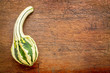 small gourd over rustic wood