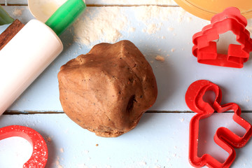 Wall Mural - Christmas gingerbread dough for homemade cakes on a light wooden background selective soft focus rustic style