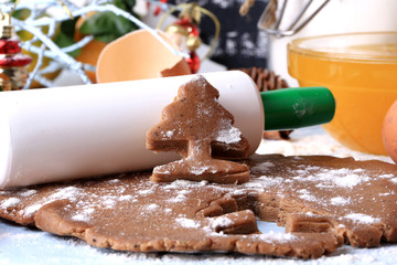 Wall Mural - cooking ginger cookies for Christmas homemade cakes on a light wooden background selective soft focus rustic style