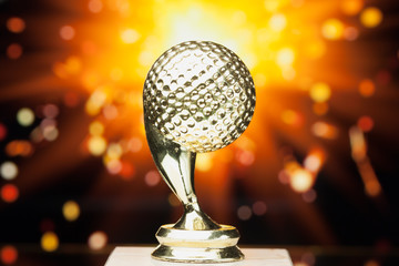 Wall Mural - golf ball trophy against shiny sparks background
