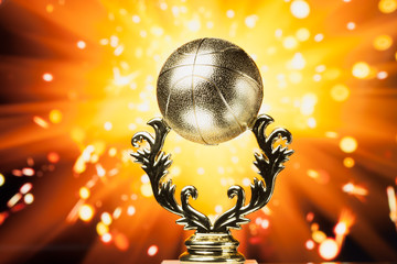 Wall Mural - basketball trophy against shiny sparks background