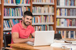 © Jale Ibrak - Happy Male Student With Laptop In Library