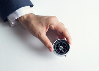 Aufkleber - Businessman with a compass holding in hand on paper background