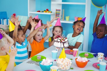 Wall Mural - Excited kids enjoying a birthday party