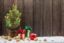 Christmas Background With Young Christmas Tree And Small Gift Bo