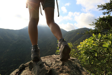 Wall Mural - young woman enjoy the view at mountain peak 