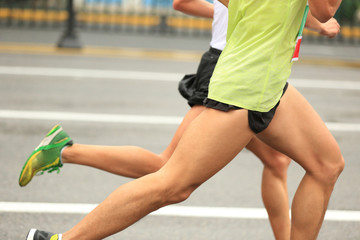 marathon runners running on city road