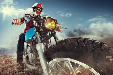 Wall Mural - Biker seat on the motorcycle under sky with clouds
