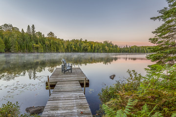 Wall Mural - Dock and Chairs on a Lake at Sunset