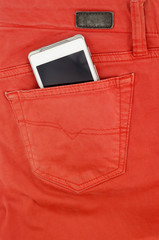 Cell phone in back pocket of red jeans