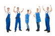 © Andrey Popov - Portrait Of Happy Janitors Standing With Arms Raised
