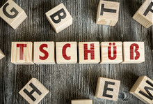 Wooden Blocks With The Text: Bye (in German)