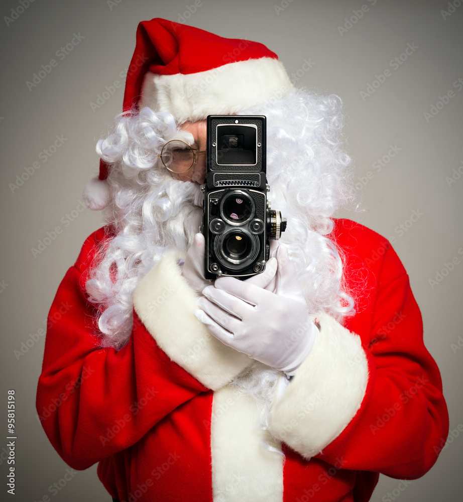 Santa using a vintage camera Stock Photo | Adobe Stock