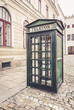 Old green retro street public call-box for telephone calls