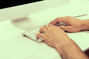 Wall Mural - Male hand on computer keyboard close up