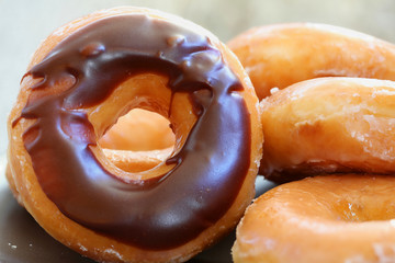 Chocolate glazed donuts background image. Macro with shallow dof.