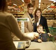 © Nejron Photo - Family buying bread in a grocery store