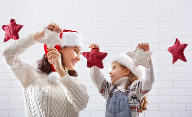 Wall Mural - mother and daughter hang a garland