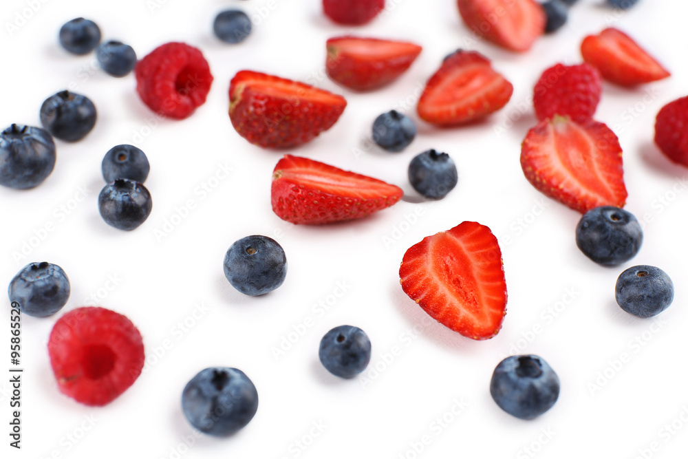 Tasty ripe berries on wooden table close up