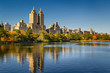 Central Park and Manhattan, Upper West Side with colorful Fall foliage. A clear blue sky and buildings of Central Park West reflecting in the Jacqueline Kennedy Onassis Reservoir. New York City.