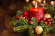 Burning candle in festive christmas arrangement