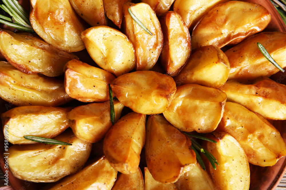 Baked potato wedges on table, top view