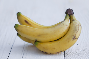 Bananas on white wooden table