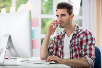 Male office worker front computer