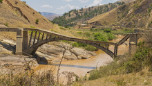 Old Broken Bridge On A Muddy River