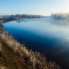 Coast With Grass Covered With Frost. River With Morning Fog.