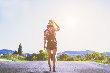 Hiker - A young hiker is walking on the road during her trip - caucasian people - people, nature and lifestyle concept